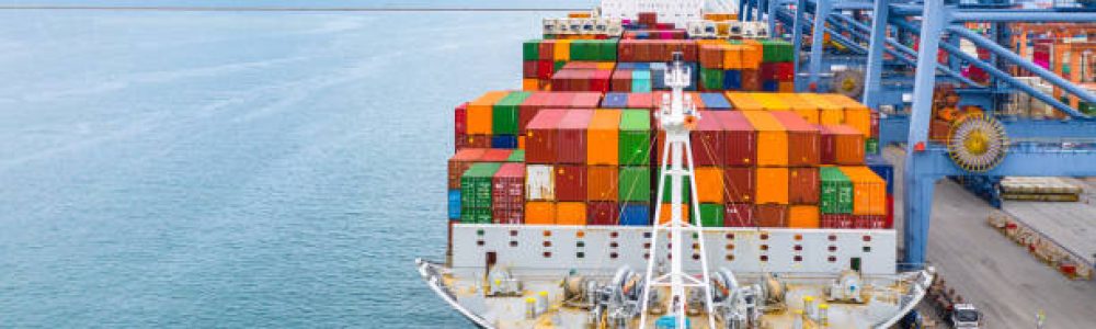 Cargo ship terminal, Unloading crane of cargo ship terminal, Industrial port with containers and container ship.
