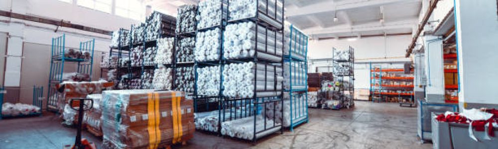 Rolled Up Cloths And Other Materials Stored In Modern Textile Factory Warehouse